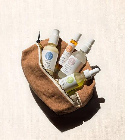 Wildcraft calm face lotion, toner, refine face serum, and eye serum in open make up bag on textured back drop