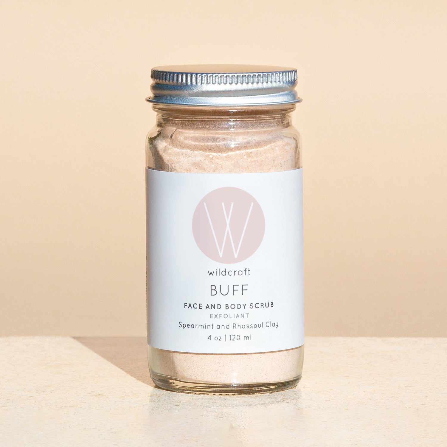 Buff Face and Body Scrub on a simple background