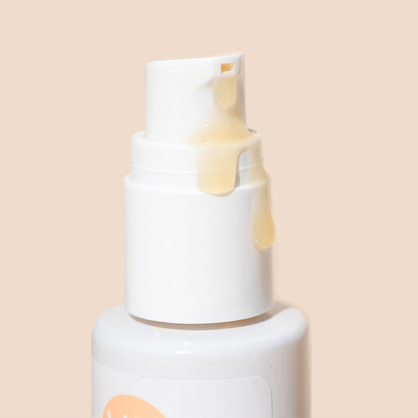 Bottle of Vitamin C Face Serum with product coming out of it.