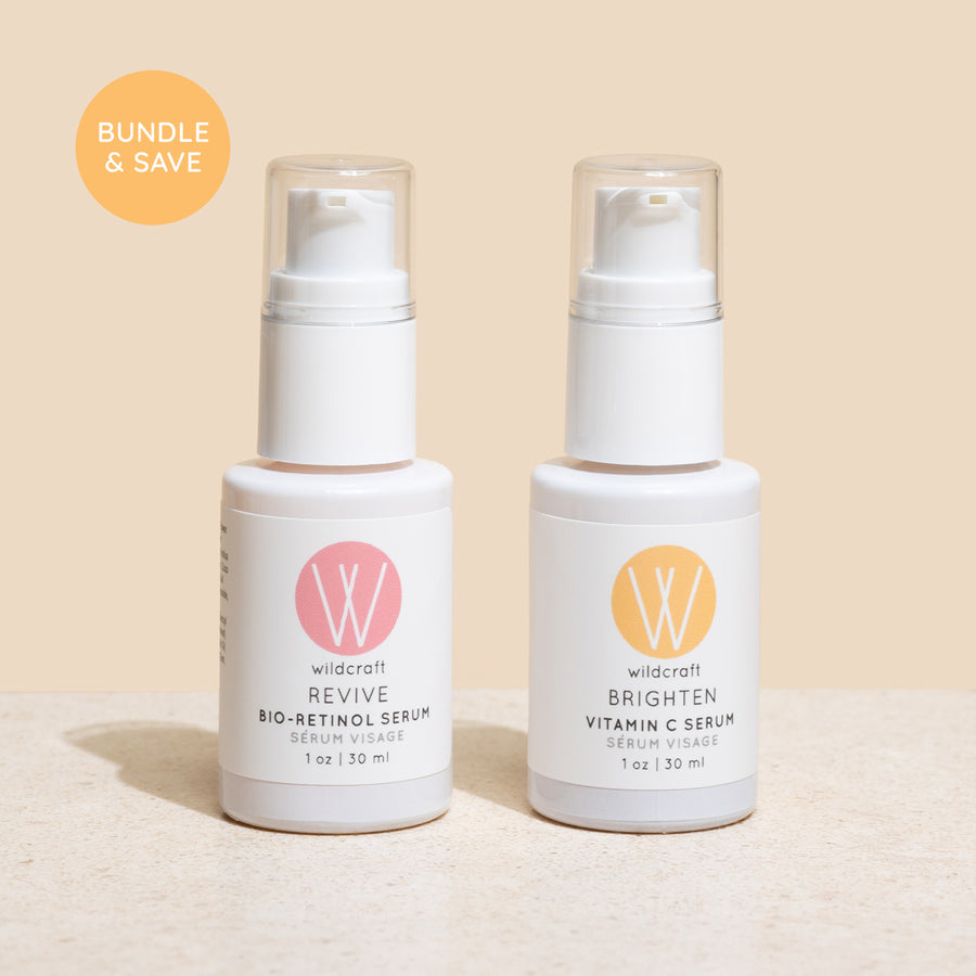 Revive Bio-Retinol Face Serum and Brighten Vitamin C Face Serum bottles on a marble background.